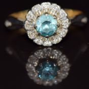An 18ct gold ring set with a zircon surrounded by diamond in a platinum setting, Birmingham 1941,