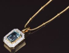 An 18ct gold pendant set with an emerald cut aquamarine of approximately 7.93ct surrounded by