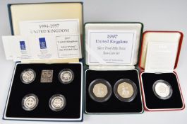 A small collection of Royal Mint silver proof coins comprising a 1994-1997 £1 coin set, a 1997 50p