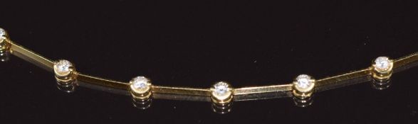 An 18ct gold necklace set with twenty round cut diamonds, the total diamond weight approximately