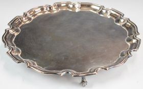 Elizabeth II hallmarked silver salver with shaped edge, raised on three scroll feet, Birmingham