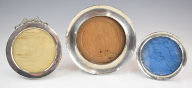 Three hallmarked silver circular photograph frames, all with easel backs, diameter of largest 16.