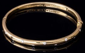 Tiffany & Co 18k gold 'Etoile' bangle set with ten round brilliant cut diamonds, stamped 750