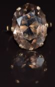 A 9ct gold ring set with an oval cut smoky quartz, 6.4g, size M