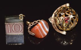 A 9ct gold charm in the form of a pierced cage / sphere encasing three dice, 9ct gold charm set with