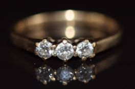 A 9ct gold ring set with three diamonds, 1.6g, size K
