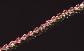 An 18ct gold bracelet set with pear cut pink sapphires, 13.1g 20.5cm