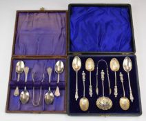 Two cased sets of four hallmarked silver teaspoons and tongs, one set with apostle finials and