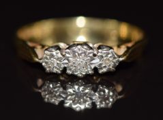 An 18ct gold ring set with three diamonds in a platinum setting, 2.5g, size L