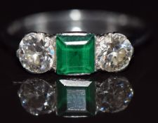 Art Deco platinum ring set with a square cut emerald each approximately 0.5ct and two transitional