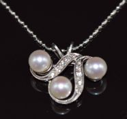 A 14k white gold pendant set with pearls and diamonds (4g) on 18k white gold chain (2.5g)