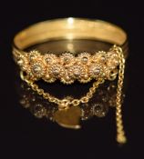 A Middle Eastern yellow metal ring with sphere and heart decoration, 3.4g, size S