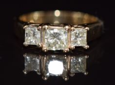 An 18ct gold ring set with three princess cut diamonds, the largest approximately 0.4ct, 3.2g,