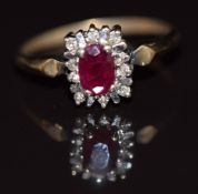 A 9ct gold ring set with an oval cut ruby and diamonds, 2.4g, size N