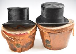 Two top hats in leather cases, one Army & Navy, aperture 20.5 x 16.5cm, the other McLaren & Son,
