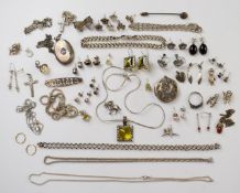 A collection of silver jewellery including chains, bracelets, lockets, earrings and charms
