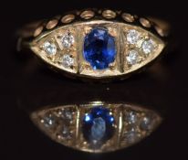A 9ct gold ring set with an oval cut sapphire and diamonds, 1.8g, size E/F