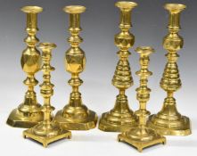 Three pairs of 19thC brass candlesticks, two pairs being ejector examples, one pair marked 'The King