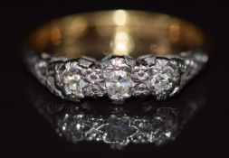 An 18ct gold ring set with three diamonds in a platinum setting, 2.9g, size J