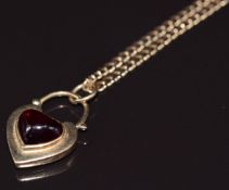 A 9ct gold heart pendant/ padlock set with a heart cut garnet, verso a locket, on 9ct gold chain,