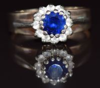 A 9ct white gold ring set with a round cut sapphire and paste, 3.9g, size O