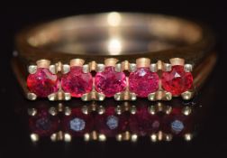 A 9ct gold ring set with five round cut rubies, 3.2g, size M