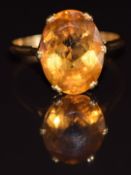 An 18ct gold ring set with an oval cut citrine, 4.9g, size S