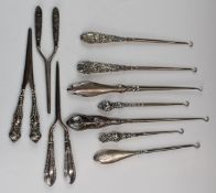 Hallmarked silver handled dressing table items comprising seven button hooks and three pairs of