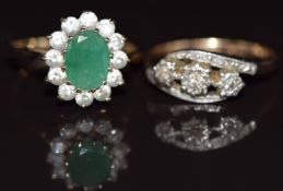A 9ct gold ring set with diamonds in a platinum setting and a 9ct gold ring set with an emerald
