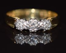 An 18ct gold ring set with three diamonds in a platinum setting, 3g, size K