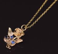 A 9ct gold pendant in the form of a rose set with sapphires, on 9ct gold chain, 5.1g