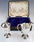 George V cased hallmarked silver strawberry set comprising cream jug and sugar sifter, in original
