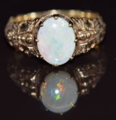 A 9ct gold ring set with an opal, with embossed decoration to the shoulders, 5.1g, size O