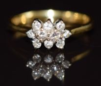 An 18ct gold ring set with diamonds in a cluster, 2.8g, size I