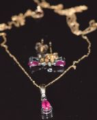 A 9ct gold pendant set with a ruby and diamond, with matching earrings, 1.9g