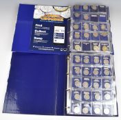 Two Change Checker coin albums containing modern collectable coins comprising eighteen £5, twenty