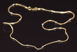 An 18ct gold necklace with white gold bead decoration, 5g