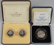 Three Royal Mint commemorative coins comprising 1989 £2 silver peidfort two coin set, and a 1994