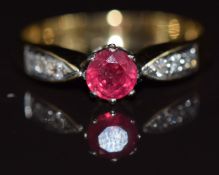 An 18ct gold ring set with a round cut ruby and diamonds, 3g, size N