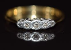 An 18ct gold ring set with three diamonds in a platinum setting, 2.2g, size P