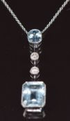 An 18ct white gold necklace set with an oval cut aquamarine of approximately 0.5ct, two diamonds