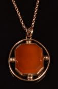 A 9ct rose gold pendant set with carnelian agate (6g) on a 9ct rose gold chain made up of faceted