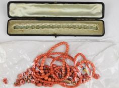A beaded single strand coral necklace with 9ct gold clasp, a double stranded coral necklace with