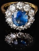 An 18ct gold ring set with a sapphire of approximately 1.5ct surrounded by ten diamonds, each