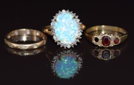 A 9ct gold ring set with a synthetic opal, and two other 9ct gold rings, 7g