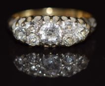 An 18ct gold ring set with seven diamonds, the largest approximately 0.4ct, 3g, size K