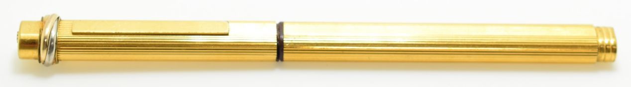 Cartier gold plated ballpoint pen with push button to lid bringing the clip out, length 13.5cm