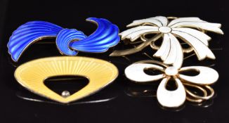 Three Norwegian silver brooches set with white and blue enamel and another silver brooch set with