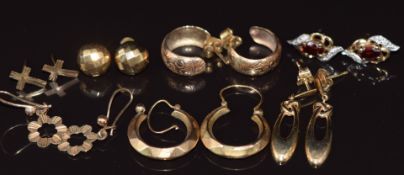 Seven pairs of 9ct gold earrings, one pair set with garnets and diamonds, 9.4g