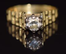 A 1970's 18ct gold ring set with a diamond of approximately 0.2ct, with textured shoulders, 3.8g,